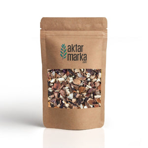 Kraft-paper resealable stand-up pouch with viewing window showing the dried lemon-ginger herbal tea blend — lemon, ginger, orange peel, hibiscus, apple, 1kg pack from Turkey.